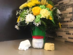 Mang-Coa-Nut butter jarred, beside a flower vase
